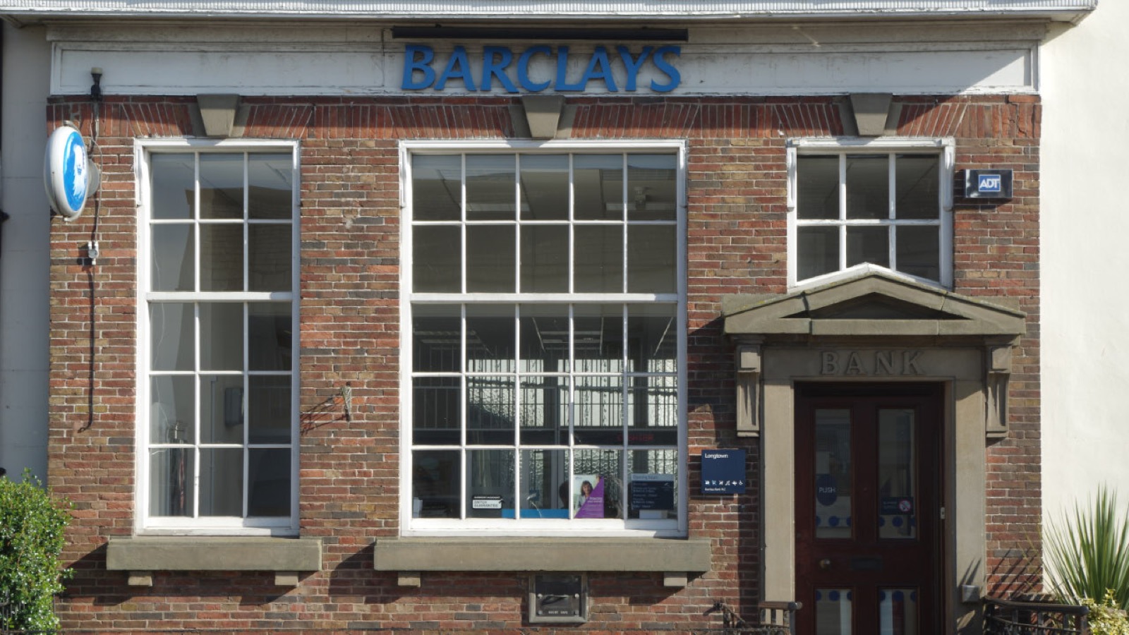 英ロングタウンのバークレイズ銀行支店。ファサードに青い「BARCLAYS」の社名ロゴと鷲のエンブレムが掲げられ、Barclays と一目で分かる店舗外観。