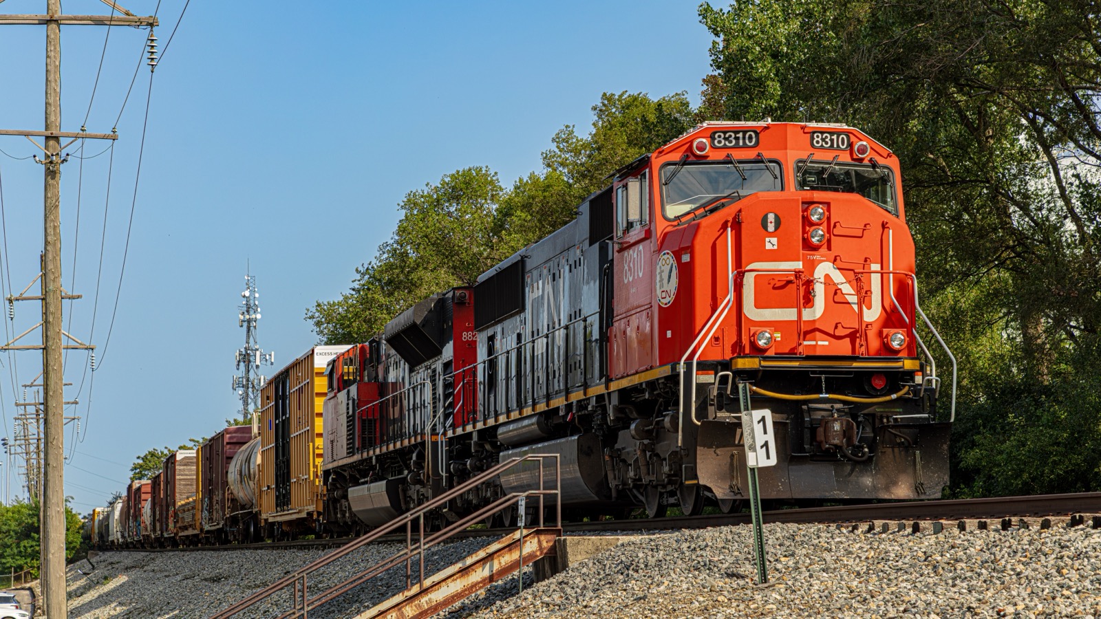 カナディアン・ナショナル鉄道(CN)の主力ディーゼル機関車8310号機。赤い前面に象徴的な白い「CN」ロゴを大きく掲げ、後続にもCN塗装の重連機を連ねて貨物列車を牽引する。