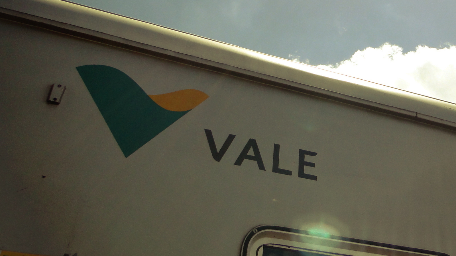 Vale S.A. のロゴと社名「VALE」を掲げた鉄道車両(ヴィトーリア-ミナス鉄道の旅客車両)。緑と橙のシンボルと社名がはっきり読み取れる。